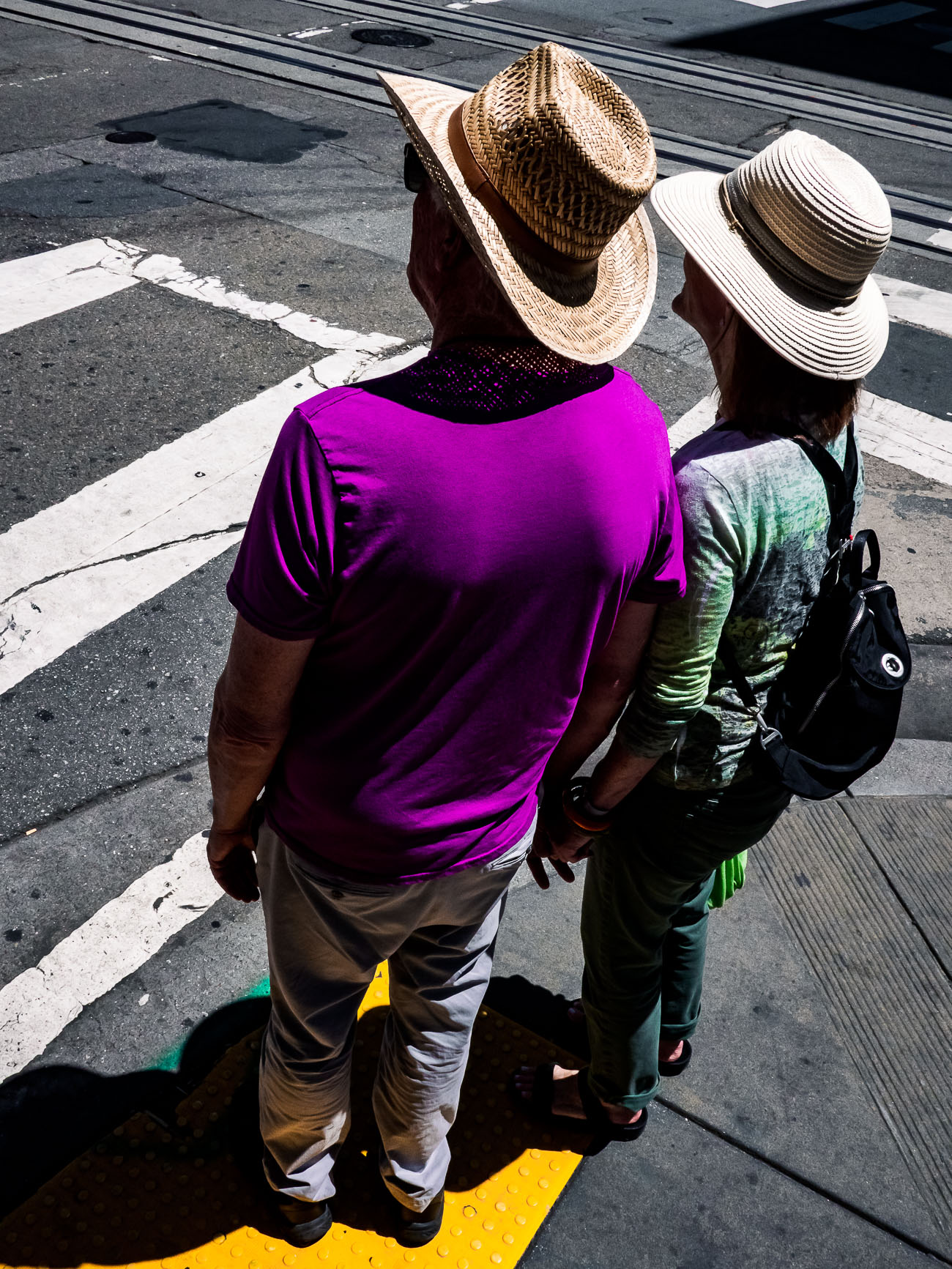 Couple waiting to cross the street in Mission district in San Francisco